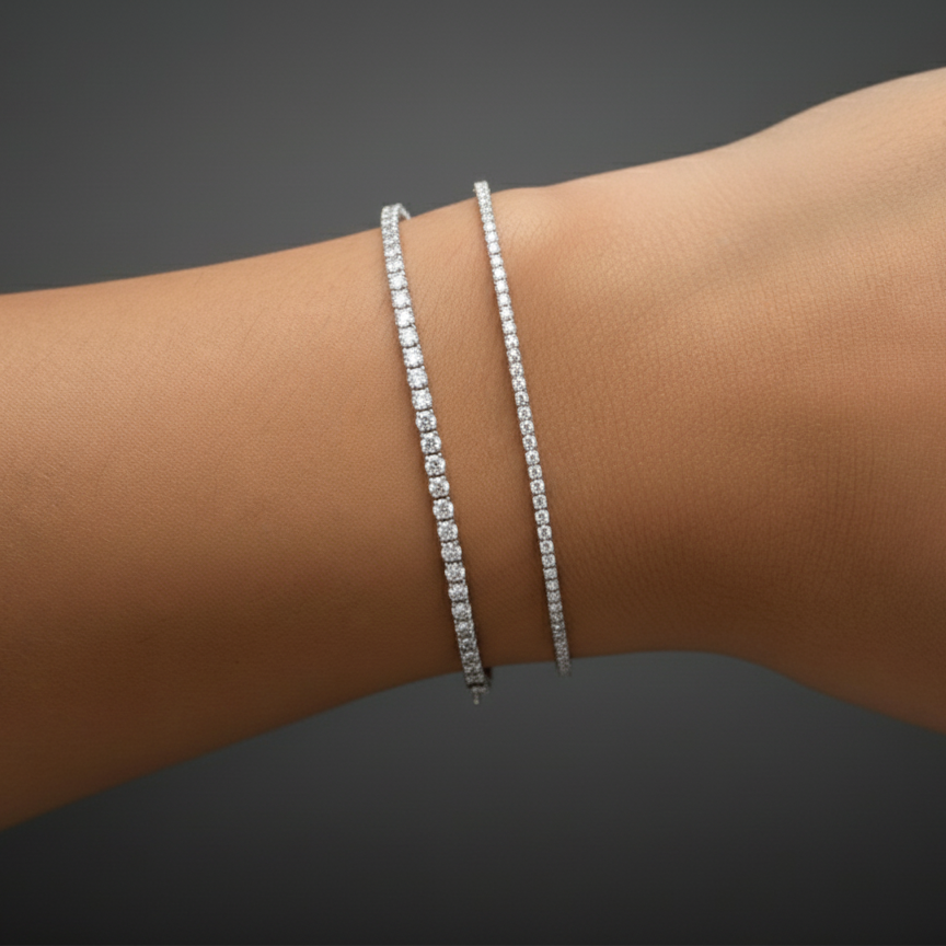 Silver bracelet on a wrist against a dark background