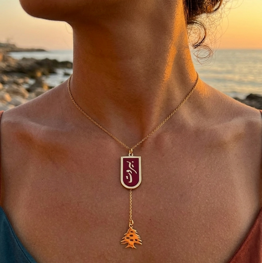 Necklace with a pendant worn by a person against a sunset ocean backdrop
