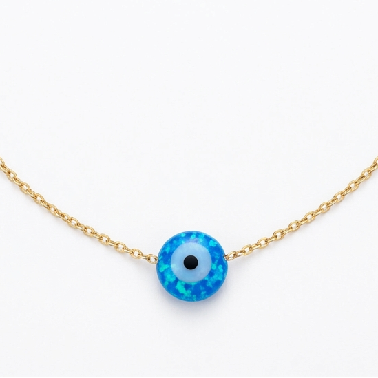 Gold bracelet with a blue evil eye charm on a white background