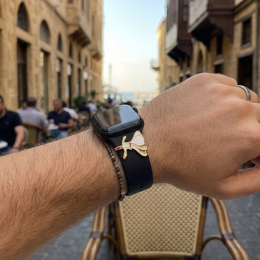 Hand wearing a smartwatch with a darwich dervish design on the band in an outdoor cafe setting in downtown beirut