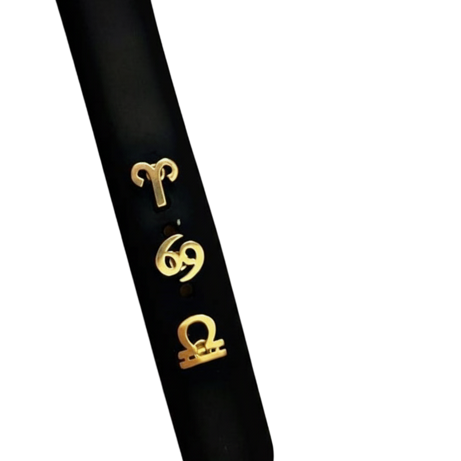 Black smart watch band with gold horoscope symbols on a white background