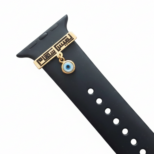Black watch strap with gold accents and a blue evil eye charm on a white background