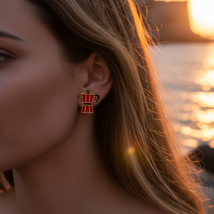 moka oro collection: a red moka pot earrings on a womans ear at the beach