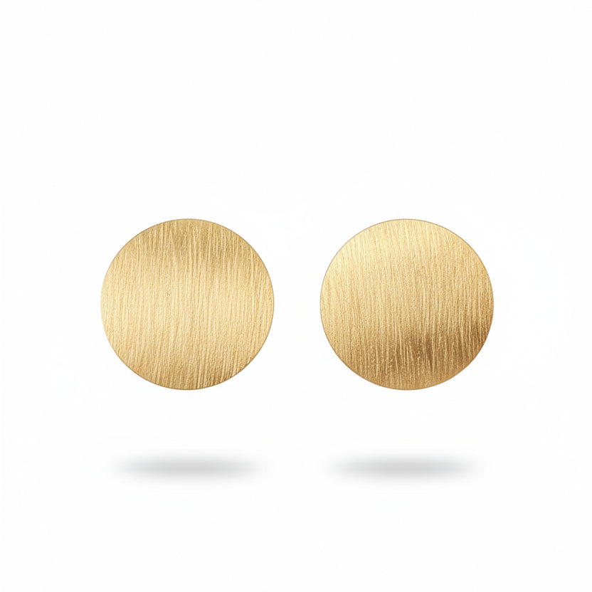 Gold earrings on a white background