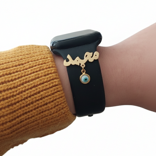 Black Apple Watch band with gold name with evil eye stone on a woman wrist on a white background