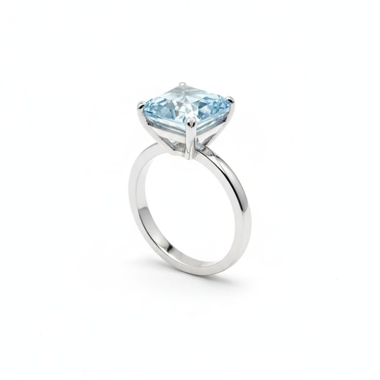 Silver ring with a blue gemstone on a white background