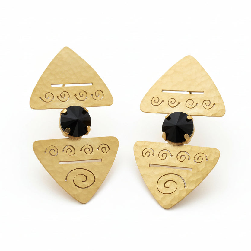 Pair of gold triangle-shaped earrings with black centers on a white background