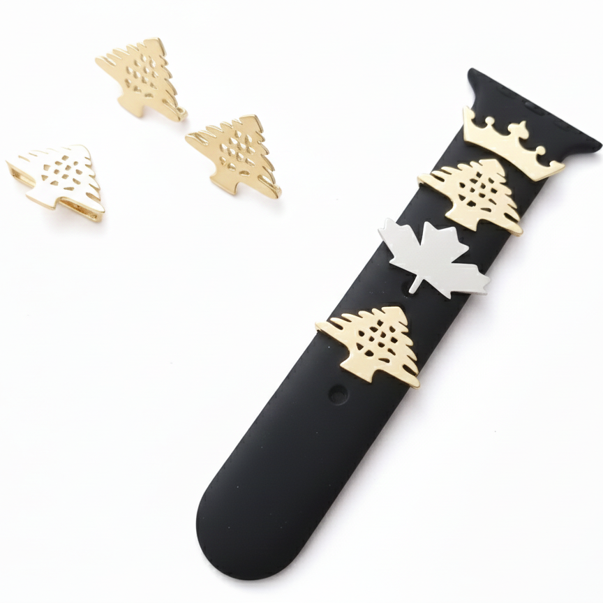 Black watch strap with gold and white cedar and maple leaf designs on a white background