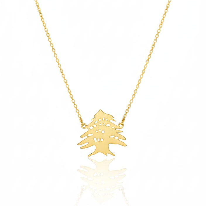 Gold necklace with a small tree pendant on a white background