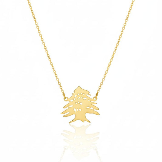 Gold necklace with a small tree pendant on a white background