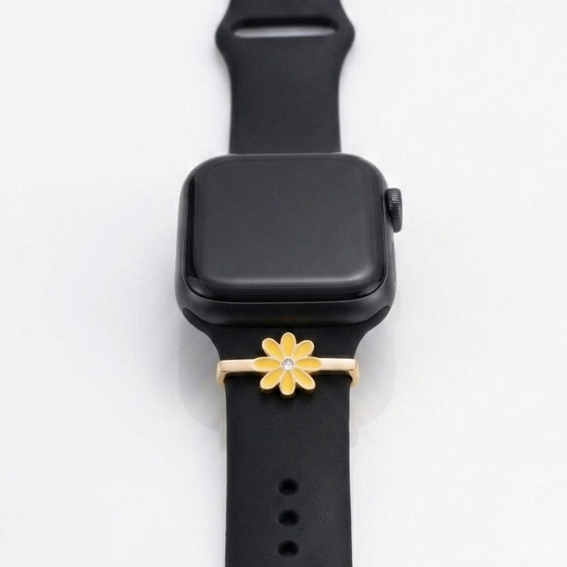 Black smartwatch with a gold flower-shaped watch band on a white background