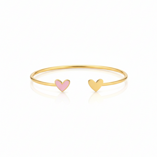 Gold bracelet with pink enamel and heart-shaped charms on a white background