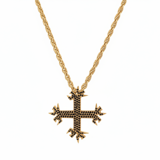 Gold necklace with a detailed cross pendant on a white background