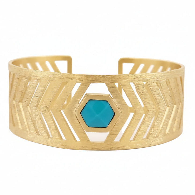 Gold bracelet with a turquoise hexagonal stone on a white background