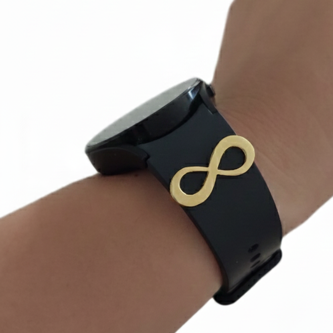 Black smartwatch with a gold infinity symbol on a wrist against a white background