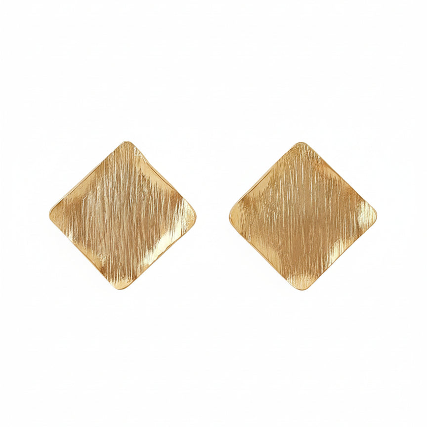 Gold square earrings against a white background