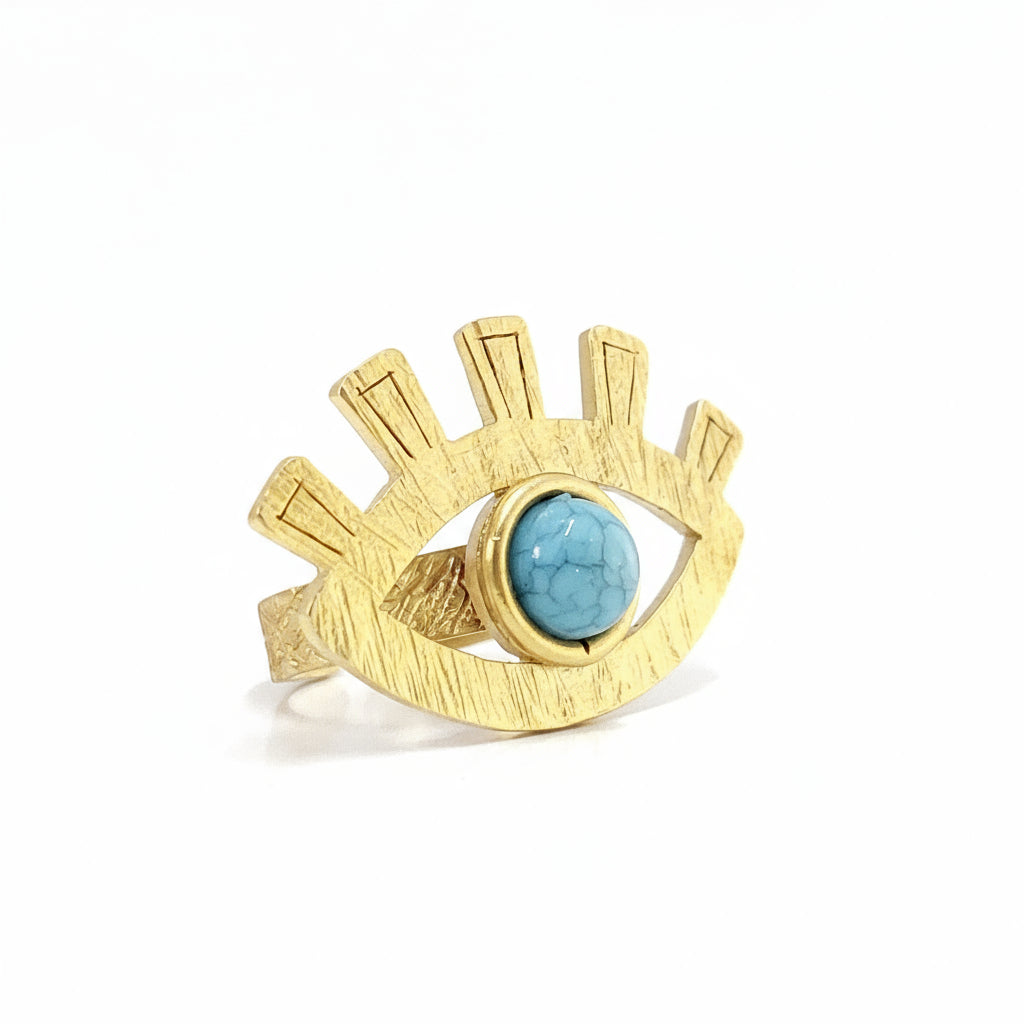 Gold ring with a turquoise stone on a white background