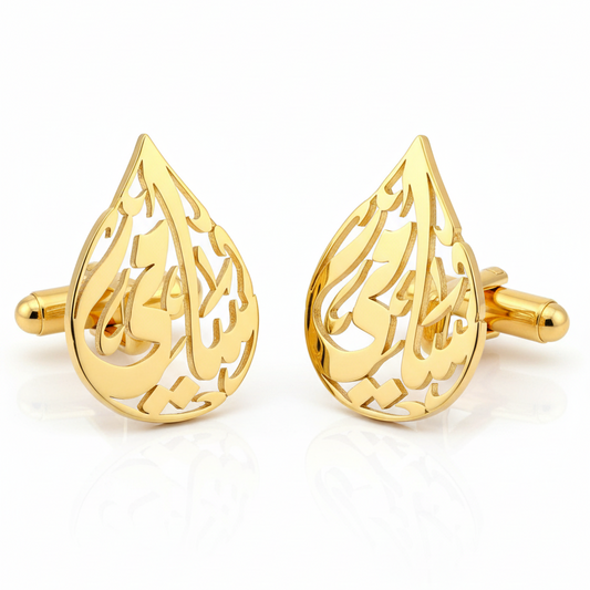 Gold teardrop-shaped cufflinks of an arabic calligraphy name on a white background