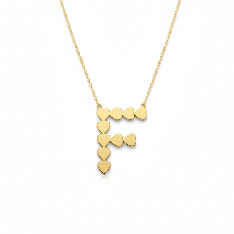 Gold necklace with heart-shaped pendants on a white background