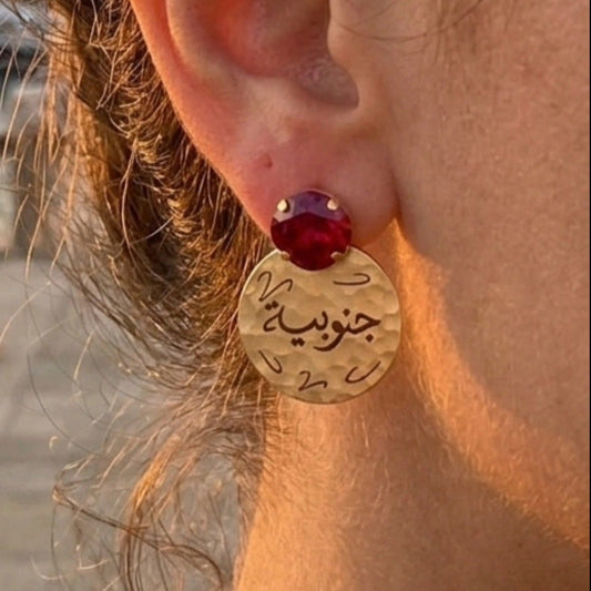 arabic calligraphy earrings with ed swarovski on a woman's ear