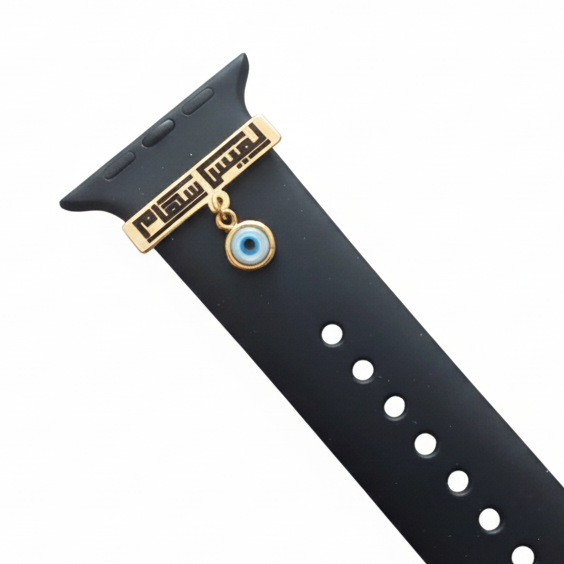 Black watch strap with gold accents and a blue evil eye charm on a white background
