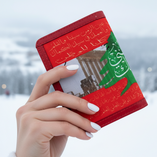 Red lebanese flag passport holder with cedar held by a hand against a snowy background in faraya