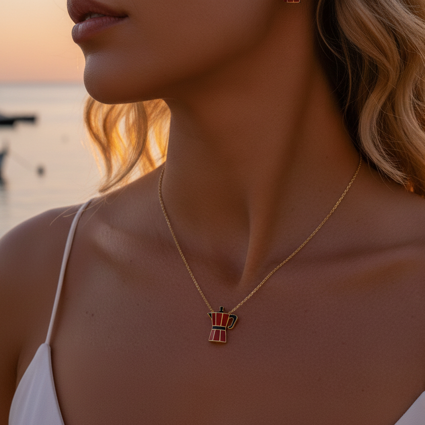 moka oro collection:  a red moka pot necklace on a womans neck at the beach