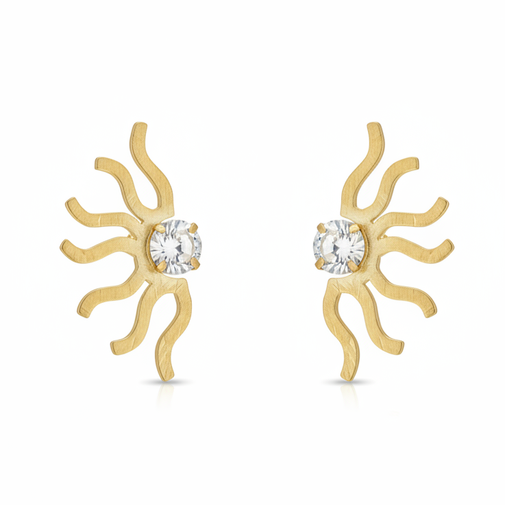 Gold sun-shaped earrings with clear gemstones on a white background