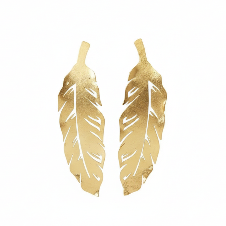 Gold feather-shaped earrings on a white background