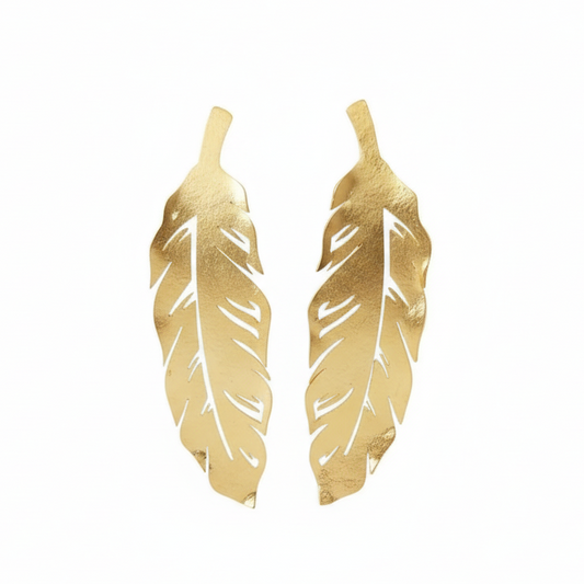 Gold feather-shaped earrings on a white background