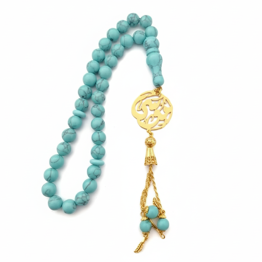 Turquoise beaded necklace with a gold pendant on a white background