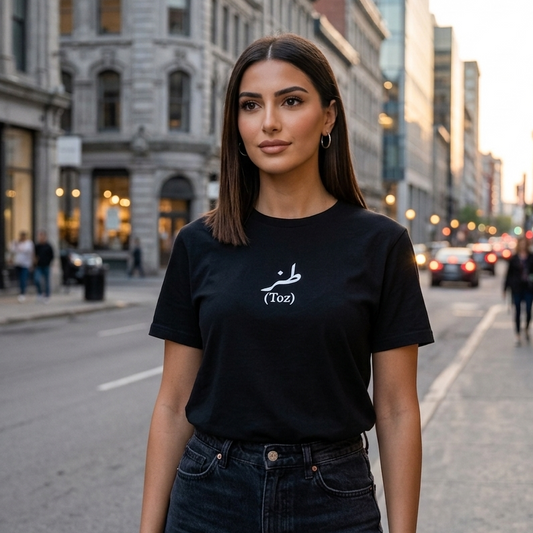 Woman wearing a black t-shirt with a logo on a city street with the word toz on it