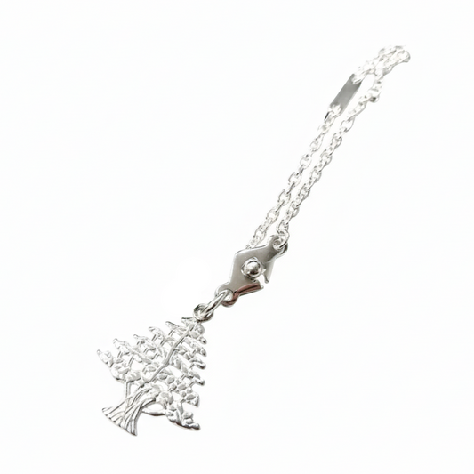 Silver keychain with a lebanese cedar charm on a white background