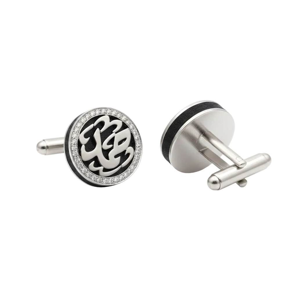 Silver cufflinks with intricate design on a white background