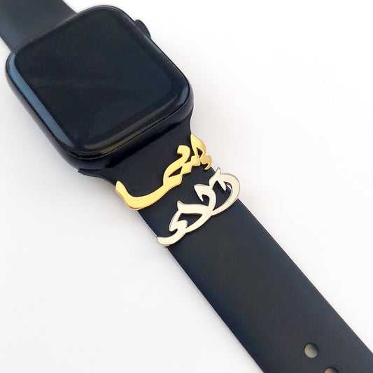 Black smartwatch with a black band on a white background with gold name and silver name