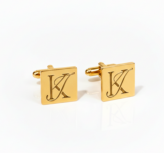 Gold square cufflinks with monogram english initials design on a white background