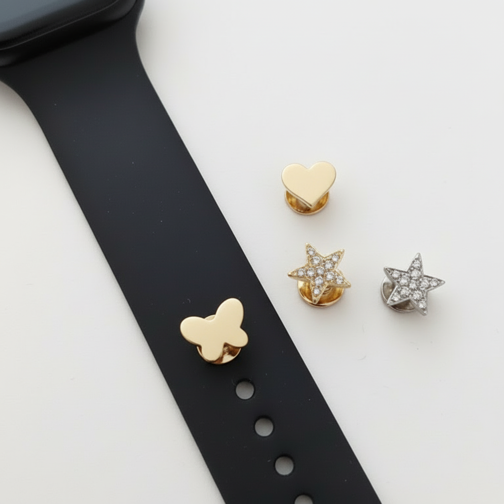 smart watch band with pins featuring butterfly, heart and star designs on a white background