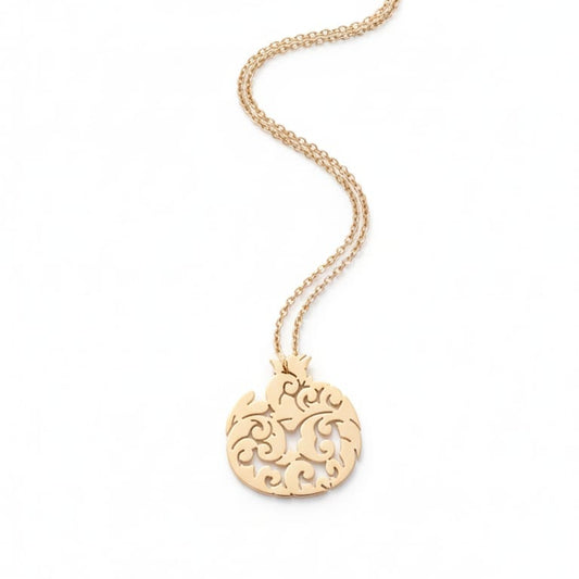 Gold necklace with a decorative pendant on a white background
