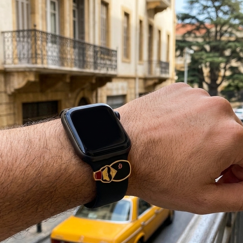 Person wearing a smartwatch with a tarboush design on band with a yellow taxi in the background on a beirut city street