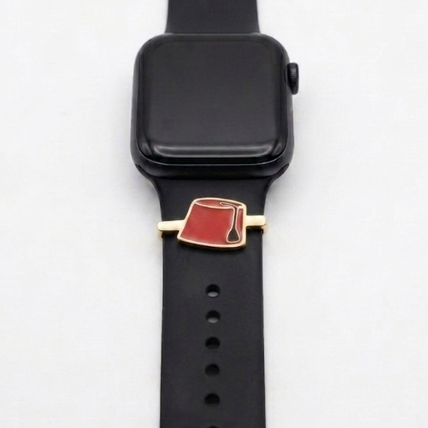 Black smartwatch with a red tarbouch gold plated band charm on a white background