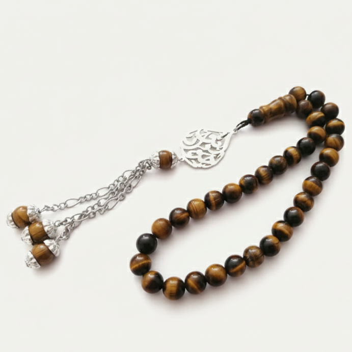 a tiger eye masbaha prayer beads by demirelli, with personalized tearshape name n shiny gold finishing