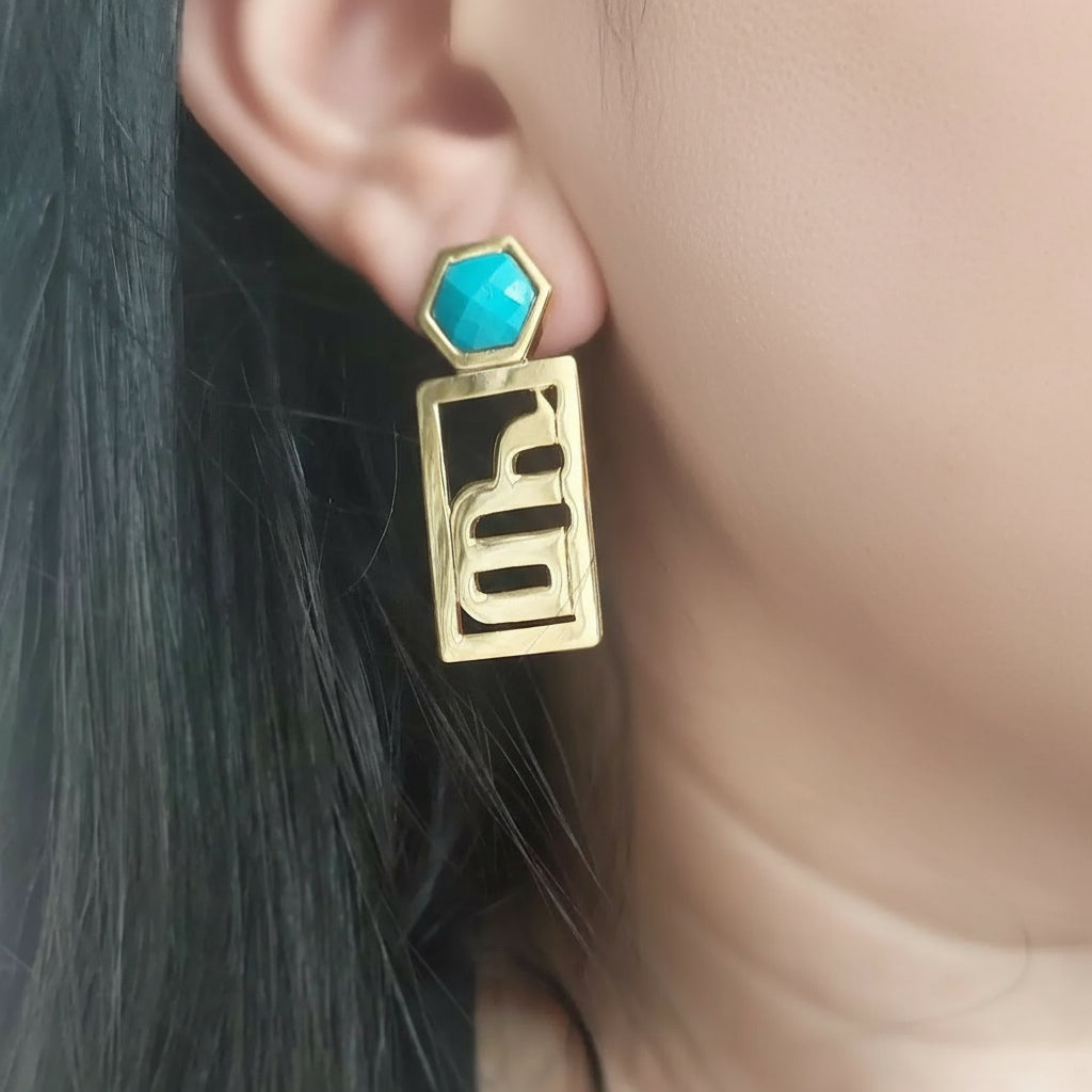woman wearing letter turquoise earrings